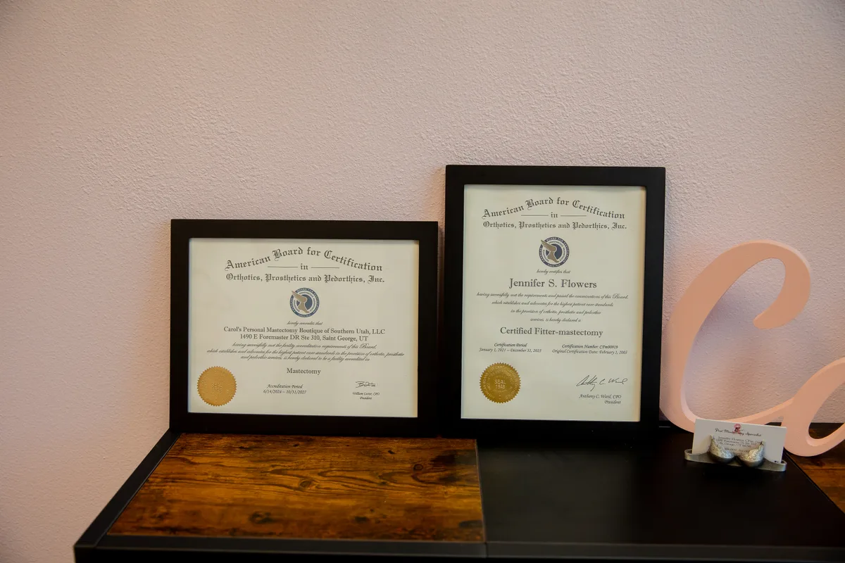 Carol's facility accreditation and Jen's Certified Fitter-mastectomy certifications, framed